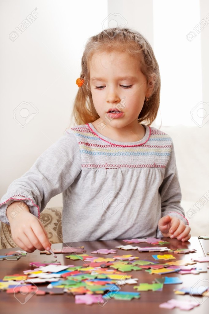 13472637-Child-playing-puzzle-Little-girl-play-at-home-Stock-Photo-puzzle-children-small