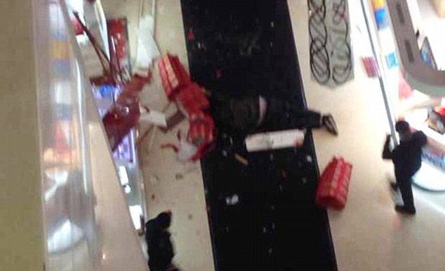 Enraged Chinese boyfriend Tao Hsiao, 38, jumped to his death after a furious row with his girlfriend, 23, after she insisted on going into yet another clothes shop. According to CCTV images the pair had already been at the shopping mall in the city of Xuzhou in Jiangsu province in the east of China for five hours when Tao had said he had finally had enough, and demanded to go home. He complained that they already had more bags than he and his girlfriend could carry, but she insisted on going into one more shop where the was a special offer on shoes. An eyewitness said: "He told her she already had enough shoes, more shoes that she could wear in a lifetime, and it was pointless buying any more. She started shouting at him accusing him of being a skinflint and of spoiling Christmas, it was a really heated argument." The shouting match ended when the man chucked the bags on the floor and jumped over the balcony, smashing into Christmas decorations on his way down before hitting the floor seven stories below causing shocked shoppers to flee in panic. Emergency services were quickly on the scene but was too late to rescue the man who was killed instantly. A shopping spokesman said: "His body was removed fairly quickly. He actually landed on one of the stalls below and then fell to the floor so although the store was damaged it meant he didn't hit anybody. This is a tragic incident, but this time of year can be very stressful for many people."