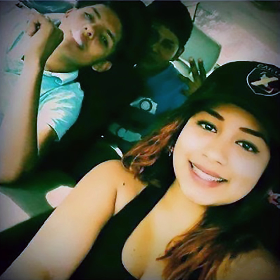 Pic shows: hitwoman with two young gang members; A Mexican hitwoman has confessed to having had intercourse with beheaded people and drinking their blood. The chilling confession was made by Juana aka La Peque" (The Littleun), who worked for the infamous Zetas cartel in Mexico, and was reported this week in local media. The small but deadly hitwoman made her confessions from one of the prisons of the north-western state of Baja California. She said: "Ever since I was a little girl I was a rebel, and then became a drug addict and alcoholic." She described how she was just 15 when she got pregnant and had a baby with a man 20 years older than her. Juana first worked as a sex worker before becoming a halconeo, a spy who would look out for police or army patrols. She said she would have to stand in position and keep an eye out for trouble for eight hours at a time. If she did it wrong she would be tied up for a week and fed only a taco a day. During her time in the cartel she describes gory moments such as watching how a man's head had been smashed open with a mace. She said: "I remember feeling sad and thinking that I did not want to end up like that." However later on it seems the littleun got used to the blood and even began to revel in it. According to Mexican site denuncias.mx she said she began to "feel excited by it, rubbing myself in it and bathing in it after killing a victim and I even drank it when it was still warm." According to the same source she even insinuated having "had sex with the cadavers of those decapitated, using the severed heads as well as the rest of their bodies to pleasure herself." Juana is still awaiting sentencing.
