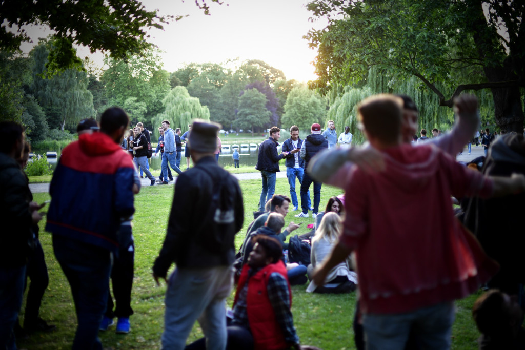 HANOVER, GERMANY - JULY 15: Young players stand at the Maschpark while holding their smartphones and playing "Pokemon Go" on July 15, 2016 in Hanover, Germany. 1.200 players have participated in the night walk through the city centre until midnight. "Pokemon Go" is a mobile game for smartphones, it uses advanced reality and geo-data to integrate the player in his search for new monsters or opponents within his location. The player now has to walk through the city, instead of spending time in front of a computer.  (Photo by Alexander Koerner/Getty Images)