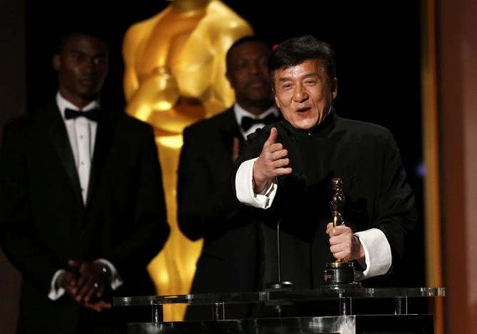 Actor Jackie Chan reacts as he accepts his Honorary Award as actor Chris Tucker (C) looks on at the 8th Annual Governors Awards in Los Angeles, California, U.S., November 12, 2016.   REUTERS/Mario Anzuoni