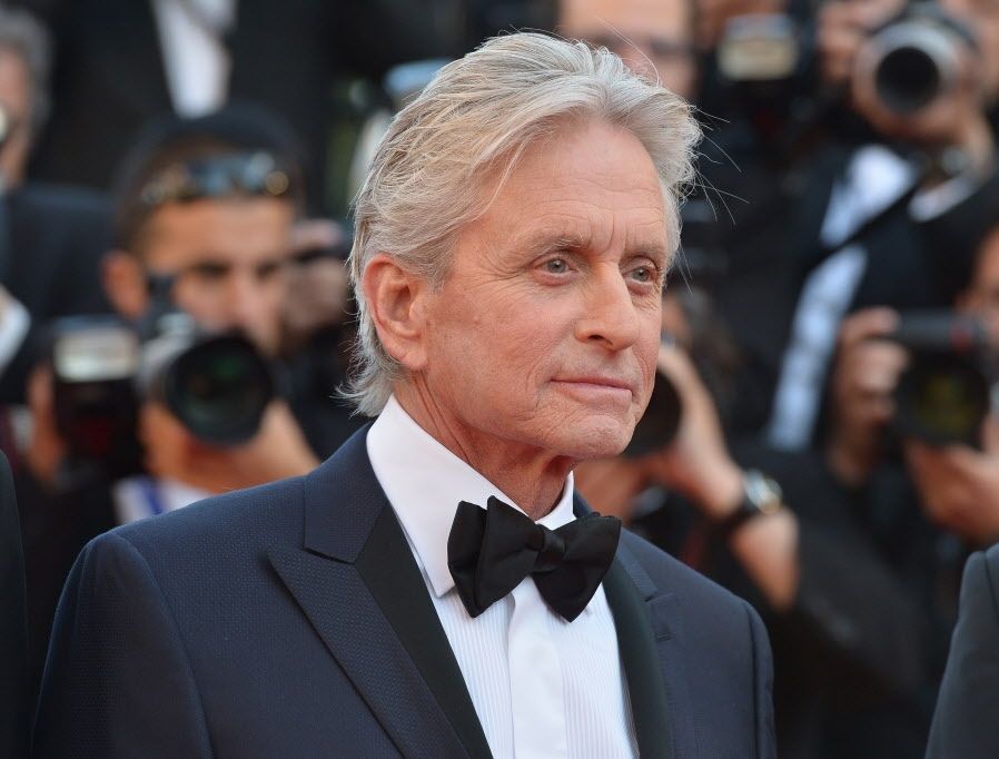 US actor Michael Douglas smiles on May 21, 2013 as he arrives for the screening of the film "Behind the Candelabra" presented in Competition at the 66th edition of the Cannes Film Festival in Cannes. Cannes, one of the world's top film festivals, opened on May 15 and will climax on May 26 with awards selected by a jury headed this year by Hollywood legend Steven Spielberg.          AFP PHOTO / ALBERTO PIZZOLIALBERTO PIZZOLI/AFP/Getty Images