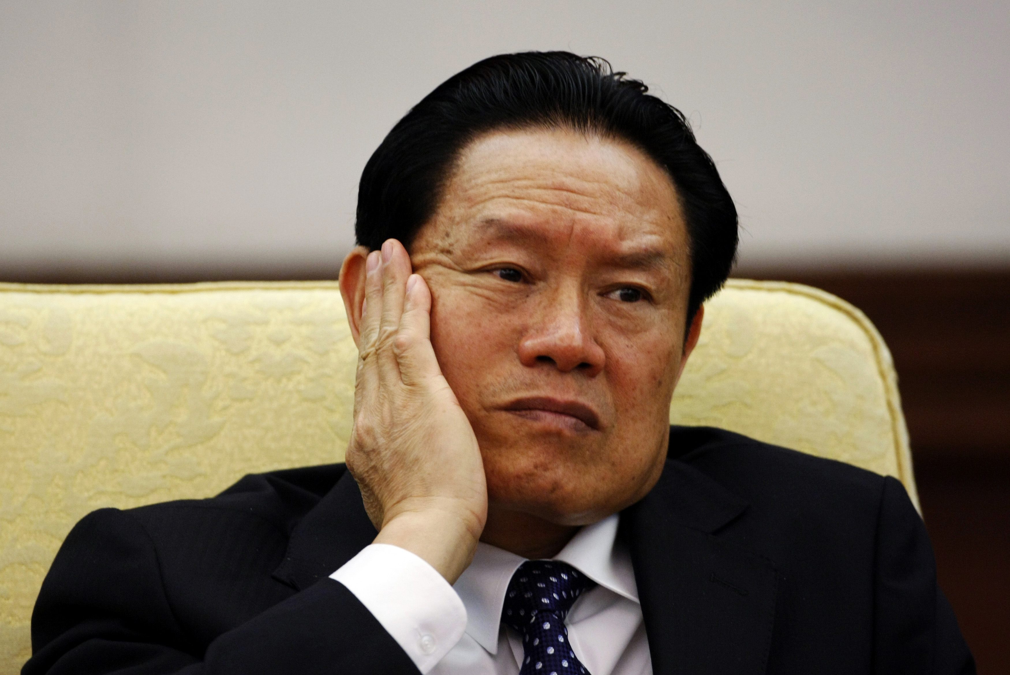 Then China's Public Security Minister Zhou Yongkang reacts as he attends the Hebei delegation discussion sessions at the 17th National Congress of the Communist Party of China at the Great Hall of the People in Beijing in this October 16, 2007 file photo. To match Special Report CHINA-PURGE/CNPC REUTERS/Jason Lee/Files (CHINA - Tags: POLITICS BUSINESS ENERGY HEADSHOT)