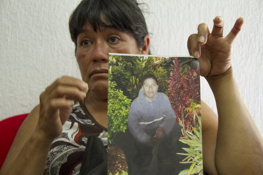 Maria Rios Cueto, holds up a photo of her nephew, Ezequiel Cordoba Rios in Tuxtla Gutierrez, Mexico, Thursday Feb. 6, 2014. Cordoba was the Mexican fisherman who died during a reported 13-month sea odyssey with Jose Salvador Alvarenga. Alvarenga, a Salvadoran fisherman, said Ezequiel died early in the voyage and that he tossed Cordoba's body overboard, while he survived by eating fish, turtles and birds. (AP Photo/Moyses Zuniga)