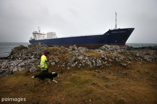A coastguard officer by the container ship Lysblink Seaways grounded at Kilchoan, West Ardnamurchan in the West Highlands.