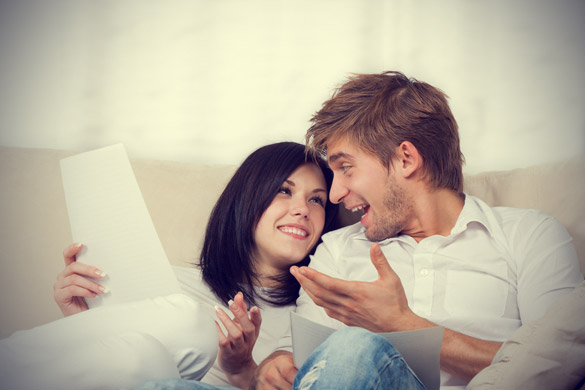 happy-couple-reading-a-letter-in-their-living-room