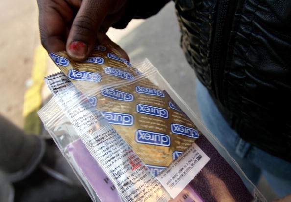 CAMDEN, NJ - FEBRUARY 17: A woman holds a packet of condoms and a sexual transmitted disease (STD) informational packet she received February 17, 2005 from a mobile health van from the Camden Area Health Education Center in Camden, New Jersey. Camden, a crime-ridden city in the south of New Jersey, has both a high prostitution rate and an escalating HIV/AIDS rate among its young people. A New York man infected with a highly drug-resistant and possibly aggressive strain of the AIDS virus has galvanized health officials around the country to consider the possibility of what some people are calling a "Super HIV strain." (Photo by Spencer Platt/Getty Images)