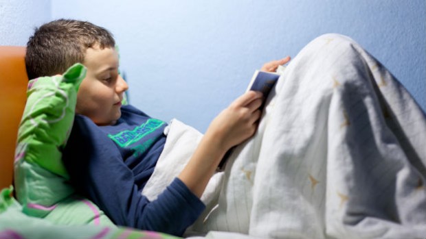 Child reading in bed