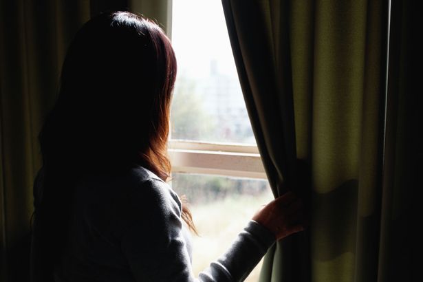 Woman-looking-out-of-window