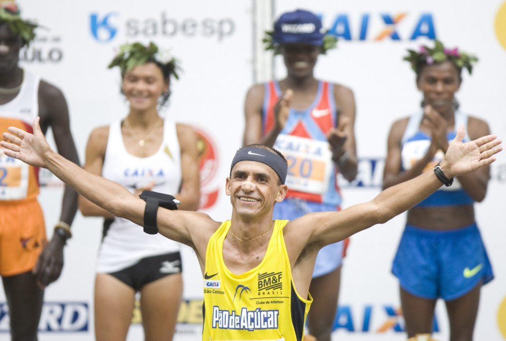 Brazil's marathon runner Vanderlei Cordeiro de Lima celebrates on the podium following his final participation in the Sao Silvestre men's road race in Sao Paulo, Wednesday, Dec. 31, 2008. The 15-kms race is held annually on New Year's Eve. (AP Photo/Alexandre Meneghini)