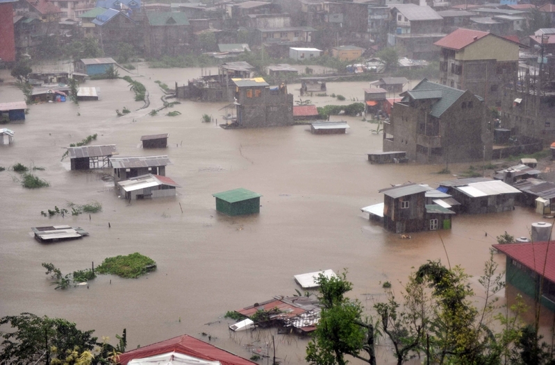A general view shows houses submerged by flooding due to heavy rains brought by Typhoon Megi in Baguio City, Benguet province, north of Manila on October 19, 2010. Philippine authorities said October 19 the death toll from Typhoon Megi had risen to three, as the storm dumped heavy rains across the main island of Luzon for a second consecutive day.  AFP PHOTO/TED ALJIBE (Photo credit should read TED ALJIBE/AFP/Getty Images)