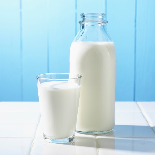 Traditional milk bottle with a glass full